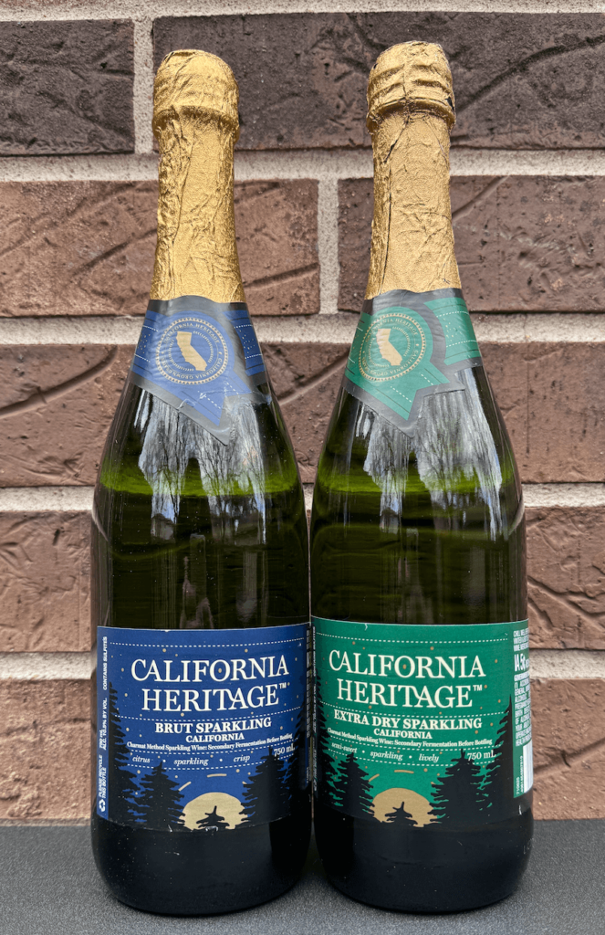 Two bottles of the California Heritage sparkling wines side by side:  the brut sparkling wine with the blue label and the extra dry sparkling wine with the green label.  